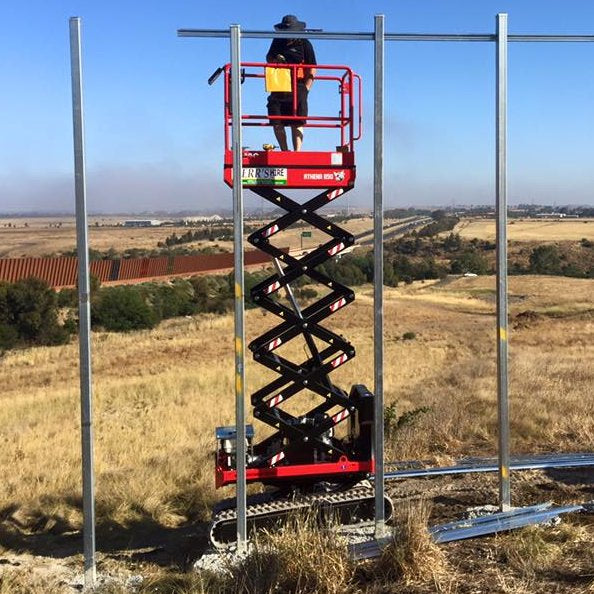 Hire Scissor Lift - 5.8m (19ft) tracked with bi-levelling capability of ...